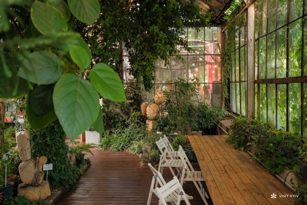 Cozy interior of the Greenhouse on VDNG in Kyiv with wooden furniture