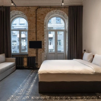 Room with a double bed and a brick wall at Globe Runner Hostel in Kyiv