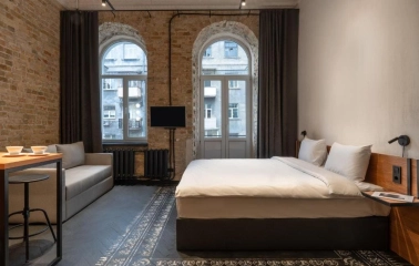 Room with a double bed and a brick wall at Globe Runner Hostel in Kyiv