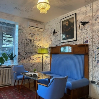 OG Burger in Kyiv - blue sofa and graffiti walls with funny picture