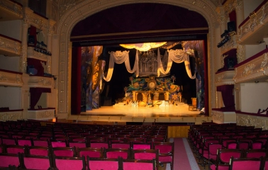 National Opera of Ukraine in Kyiv - grand stage view framed by red velvet curtains featuring a fairytale castle set design