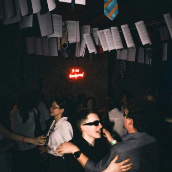 Vechirochka - party interior with papers and ties hanging from ceiling