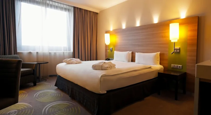 Large double bed with white linens in a Holiday Inn Kyiv room