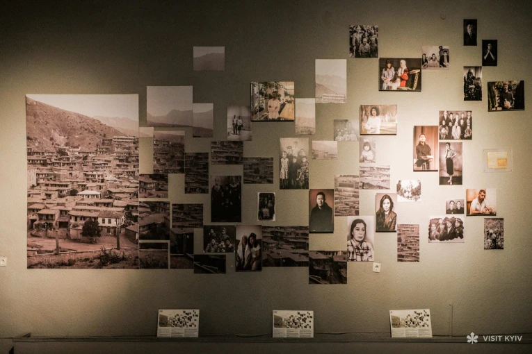 Wall with archival photographs and portraits of people inside the War Museum in Kyiv