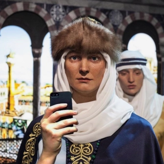 Muzei Stanovlennia Ukrainskoi Natsii in Kyiv - close-up of a realistic wax figure in medieval Kyivan Rus headwear holding a modern smartphone