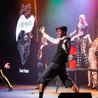 Freedom Hall in Kyiv - smiling performer gesturing on stage during a theatrical show