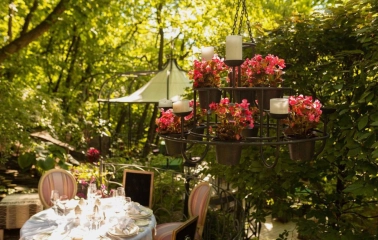 Terasa - flower chandelier above table on sunny garden terrace