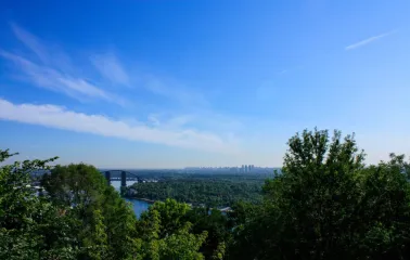 View from Volodymyrska Hill to the Dnipro River, the pedestrian bridge and the panorama of Kyiv