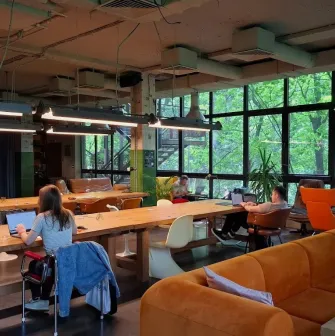 Generator - spacious coworking area with long desks, chairs, and good lighting