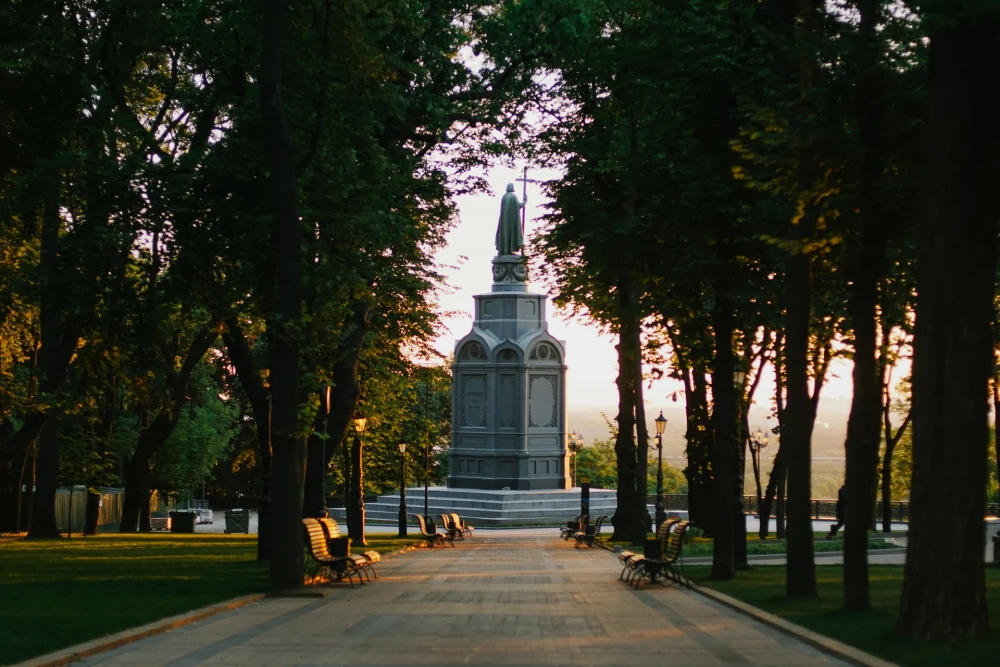 Monument to Volodymyr the Great - view of the statue standing at the end of a shady tree-lined park alley