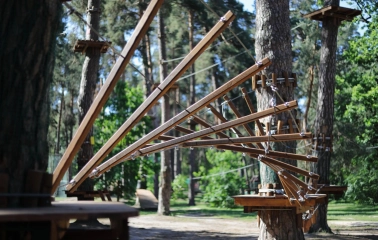 Seiklar Park in Kyiv - complex fan-shaped wooden obstacle attached to a pine tree trunk