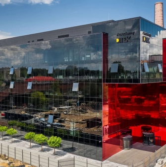 Glass building with a red insert in the UNIT.City innovation park in Kyiv