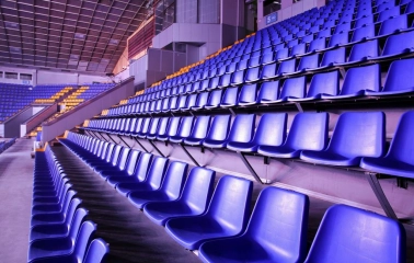 Palats Sportu in Kyiv - empty rows of blue seats rising steeply towards the ceiling structure of the arena