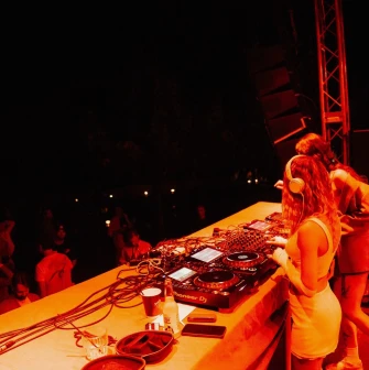 Kureni - female DJs performing on stage under red lighting
