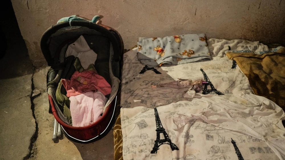 War Museum in Kyiv - basement shelter living space with a baby stroller