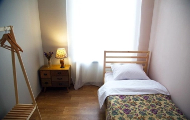 Single room with a wooden bed at Kashtan Guest House in Kyiv