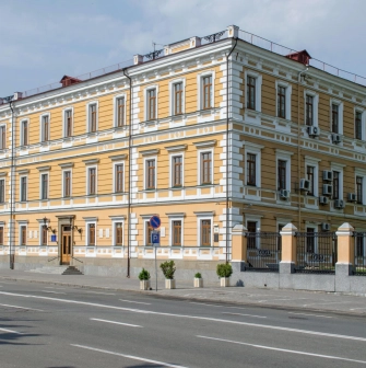 Volodymyrska Street in Kyiv- elegant yellow historical mansion with white rustication