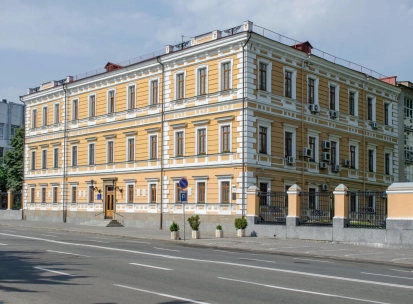 Volodymyrska Street in Kyiv- elegant yellow historical mansion with white rustication