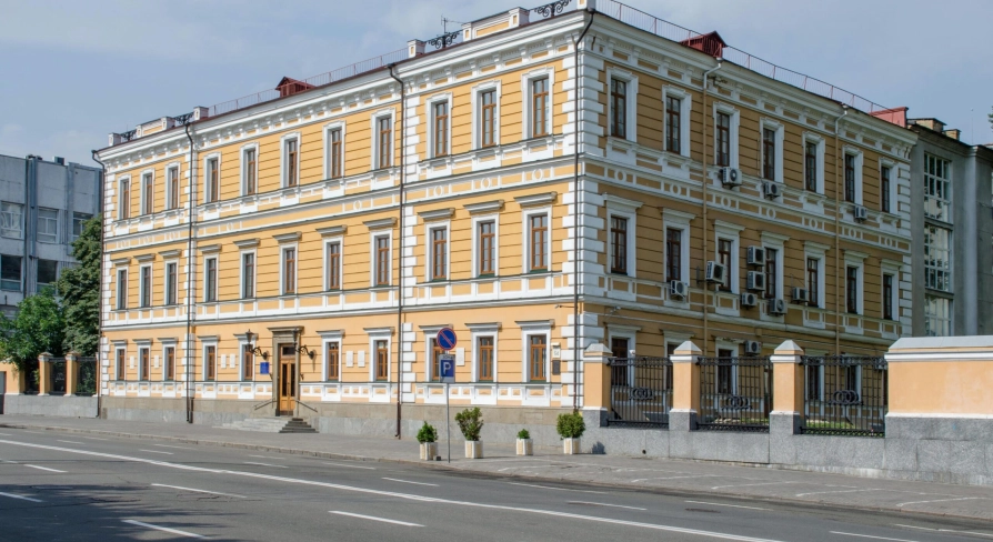 Volodymyrska Street in Kyiv- elegant yellow historical mansion with white rustication
