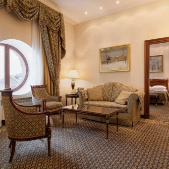 Premier Palace - elegant seating area in a hotel suite with a luxurious sofa