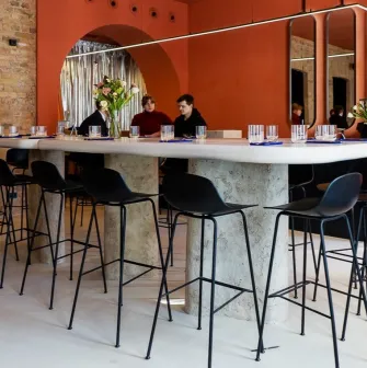 Center table with high chairs in the Pure & Naive restaurant in Kyiv with a modern design