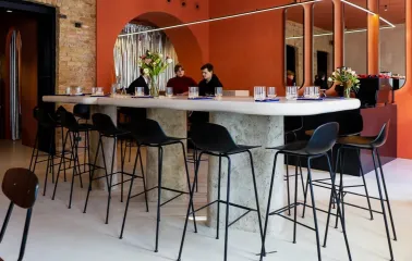 Center table with high chairs in the Pure & Naive restaurant in Kyiv with a modern design