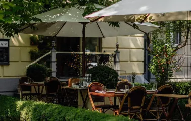 Summer terrace of La Veranda restaurant in Kyiv in the middle of a green garden