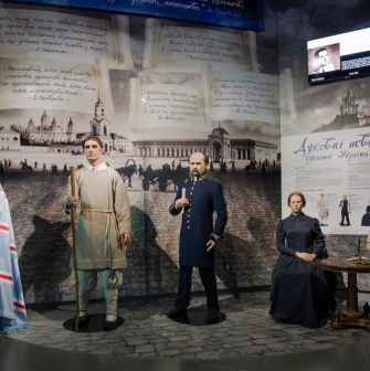 Muzei Stanovlennia Ukrainskoi Natsii in Kyiv - lifelike wax figures of prominent 19th-century Ukrainian intellectuals standing together against a background of poetic quotes