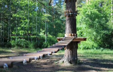 Seiklar Park in Kyiv - wooden suspension bridge with logs swinging in the air