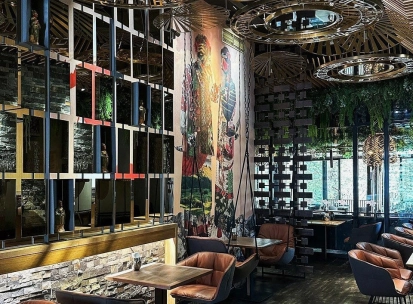 Restaurant Chary - large dining hall with a cultural mural and wire mesh screen dividers