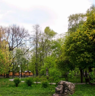 A green lawn with a stone sculpture at Volodymyr's Hill in Kyiv
