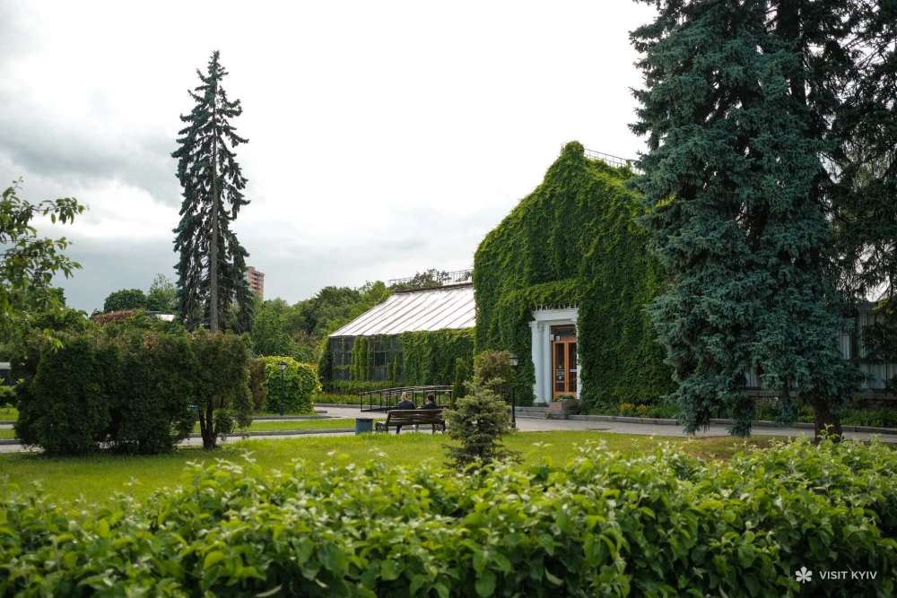 The facade of the Greenhouse at VDNG in Kyiv covered in ivy