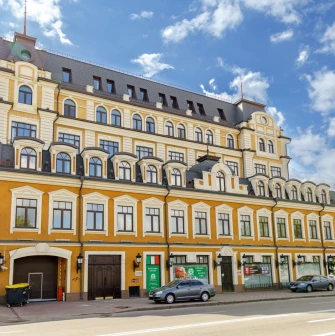 Verkhnii Val in Kyiv - bright orange building with a mansard roof