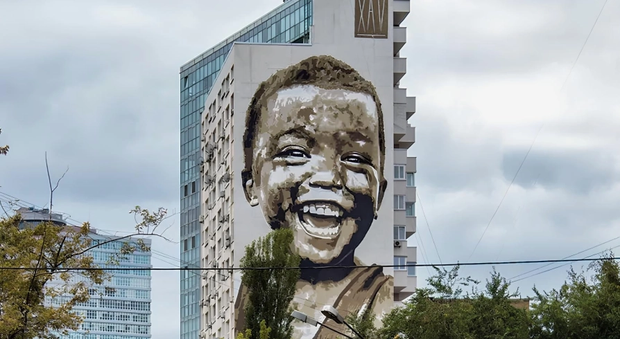 Simple happiness in Kyiv - fresco portrait of a boy - a massive portrait symbolizing joy in little things and hope