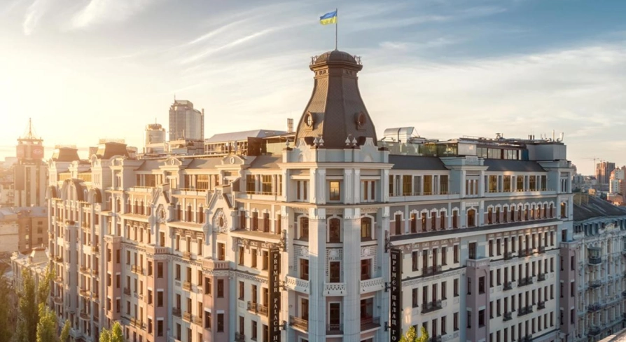 The facade of the Premier Palace Hotel in Kyiv with the Ukrainian flag on the roof