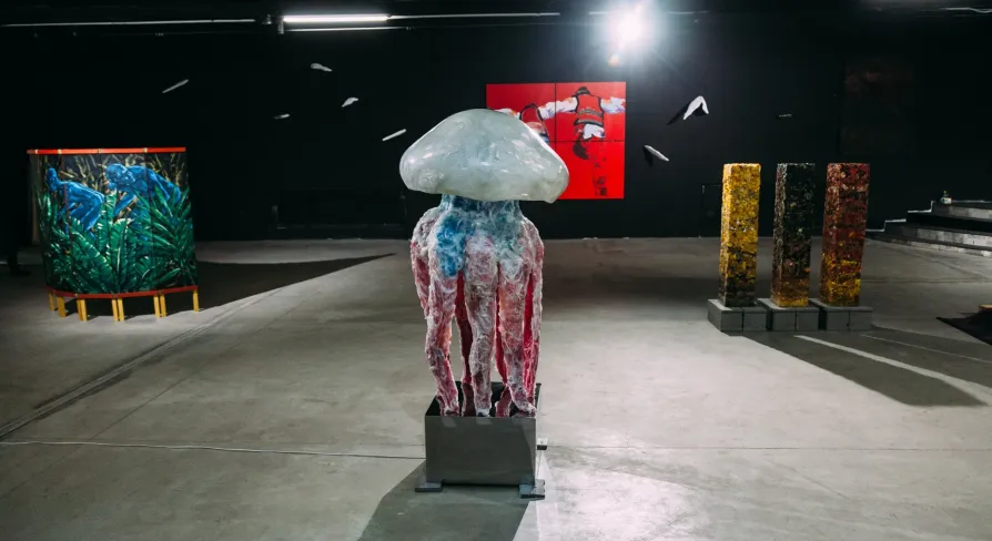 Lavra Gallery in Kyiv - large jellyfish sculpture standing in the center of a dark modern art hall