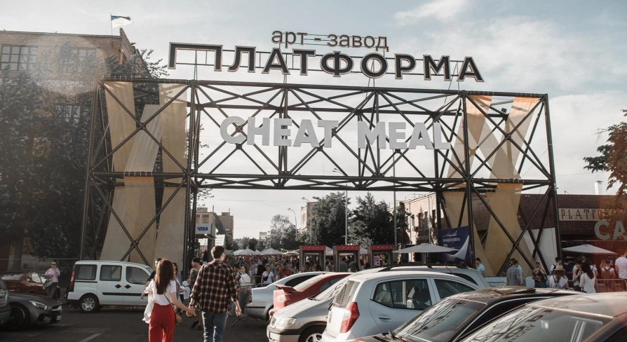 Art-zavod Platforma in Kyiv - massive industrial metal entrance arch with huge white letters welcoming visitors to a street food festival