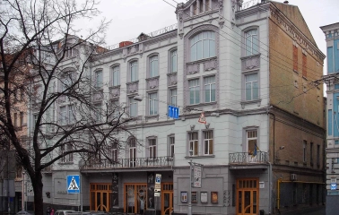Molodyi Teatr in Kyiv - historic grey facade of the theater building on Prorizna street featuring intricate architectural stucco and arched windows