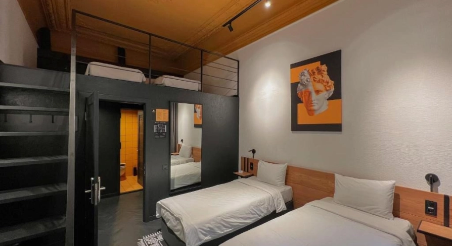 Two-storey room with two single beds and a mezzanine bed at Globe Runner Hostel in Kyiv