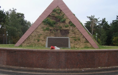 Peremoha Park in Kyiv - Kurgan of Immortality memorial shaped like a grassy pyramid with a dedication plaque
