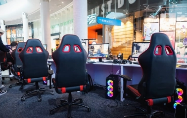 Ocean Plaza in Kyiv - modern esports gaming zone inside the mall equipped with professional black and red chairs and computers with neon RGB lighting