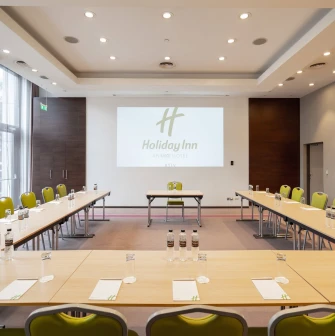 Office meeting room with a table and screen at Holiday Inn
