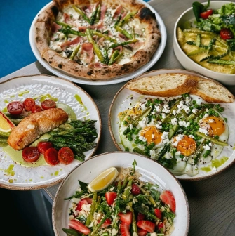Restaurant Momenty - five plates of various spring dishes including pizza and salads