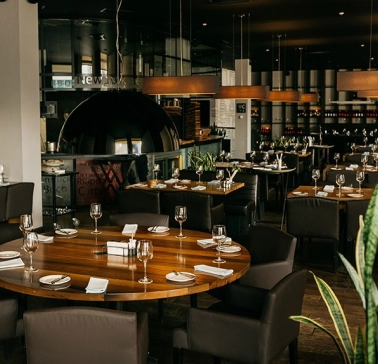 Modern interior of Beef Meat & Wine restaurant in Kyiv with wooden tables and elegant lighting