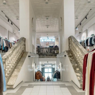 A grand stone staircase leading to the second floor of the Vsi Svoi store in Kyiv