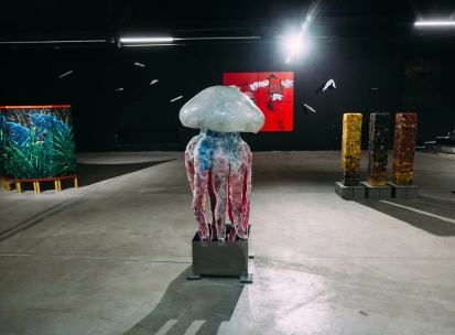 Lavra Gallery in Kyiv - large jellyfish sculpture standing in the center of a dark modern art hall