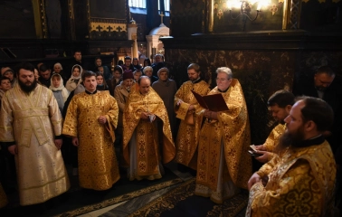 St. Volodymyr's Cathedral in Kyiv - group of priests in gold robes reading prayer books