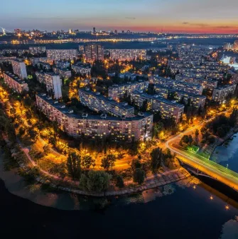 Rusanivska Naberezhna in Kyiv - aerial night view of the island district glowing with streetlights