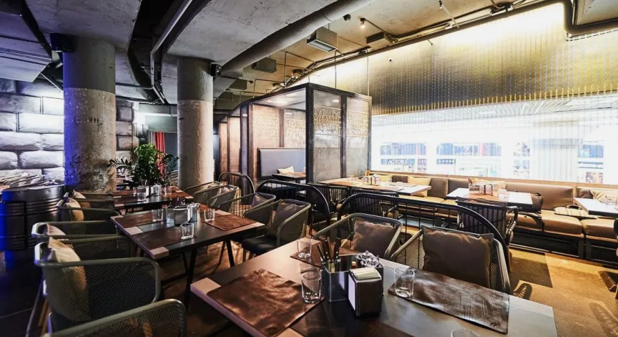 Restaurant Ostannia Barykada - main dining area with industrial design and banquette seating