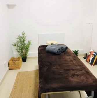 Brown massage couch with towels in Aura Spa room